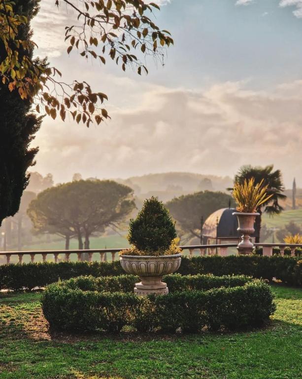 Fountain and clipped hedges in the gardens of Castello di Spessa