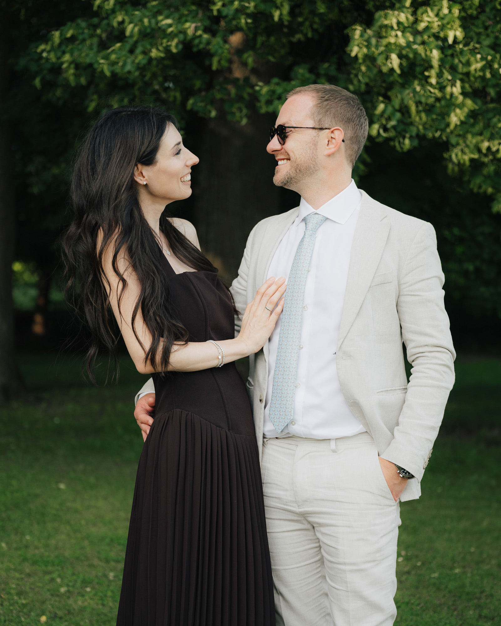 Neža and Miha smiling at each other in a green garden