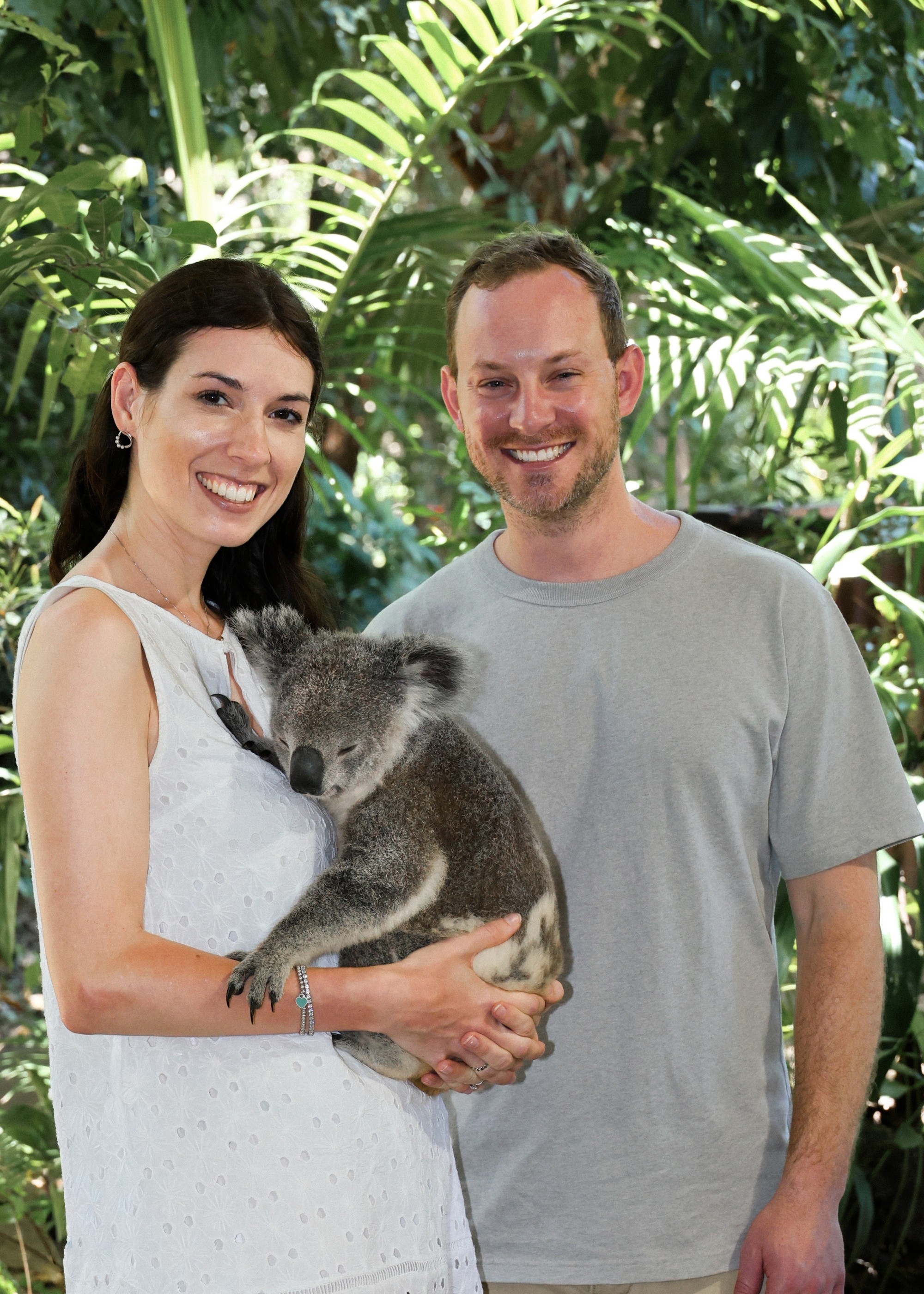 Neža and Miha smiling together while holding a koala